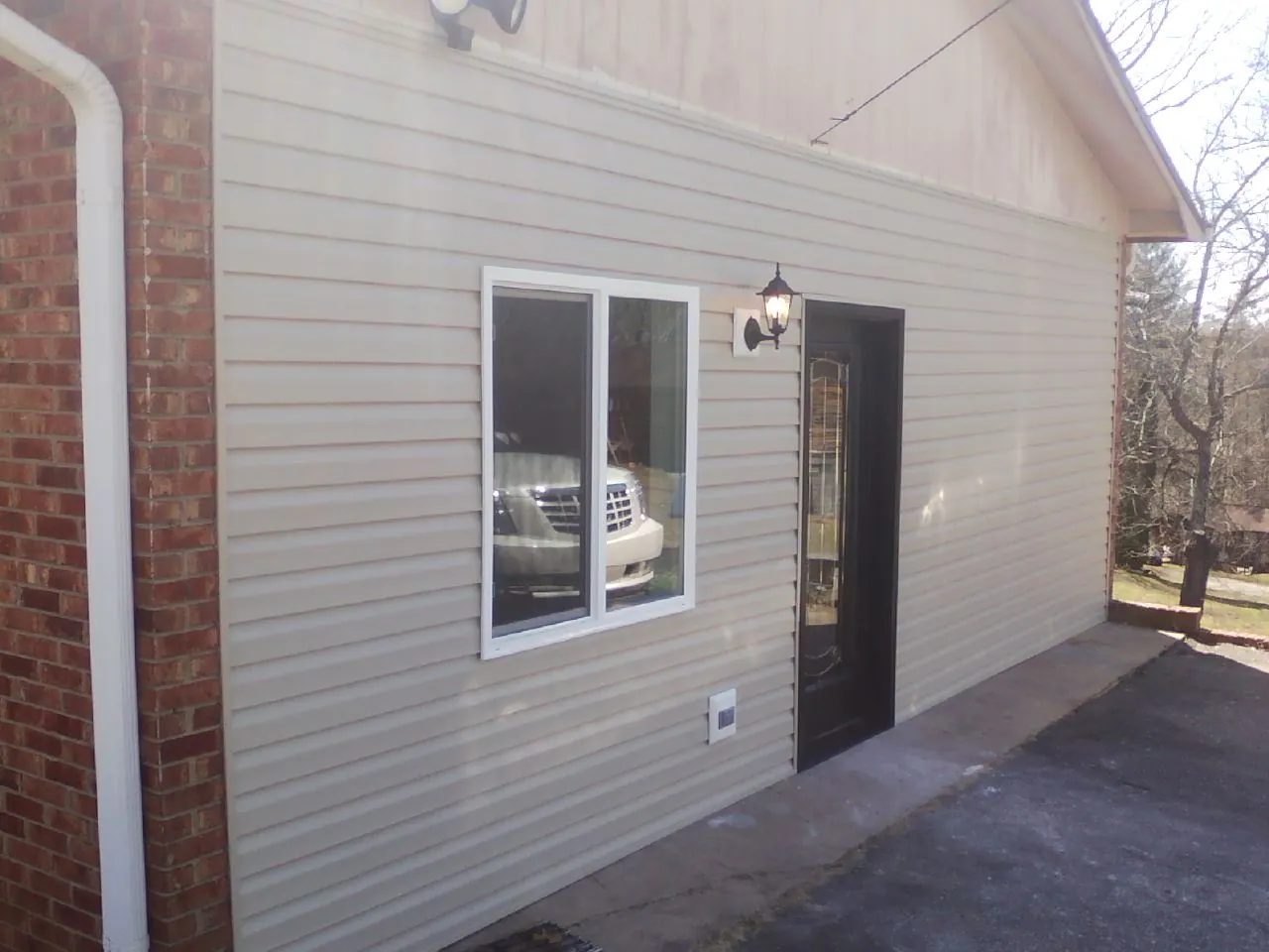 New vinyl siding and entry door on a room addition in Fontana